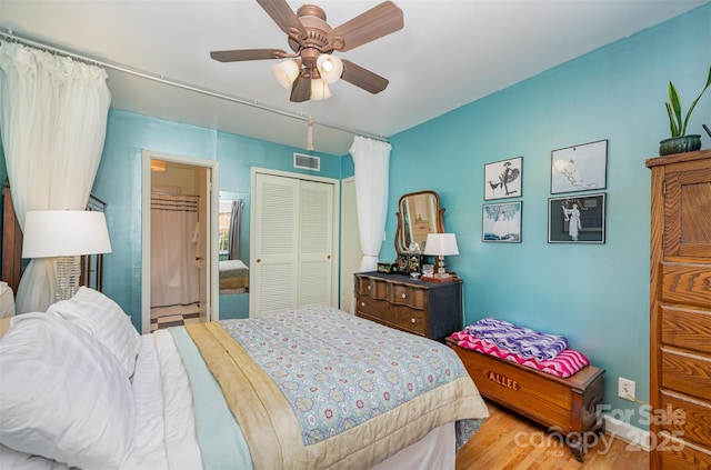 bedroom featuring a closet, visible vents, a ceiling fan, wood finished floors, and baseboards