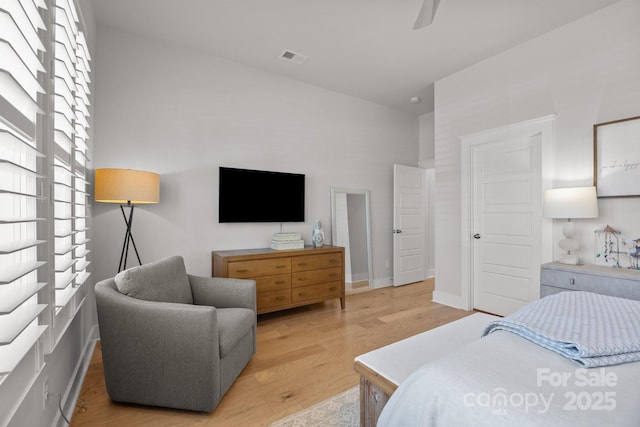 bedroom featuring visible vents, light wood-style flooring, and ceiling fan