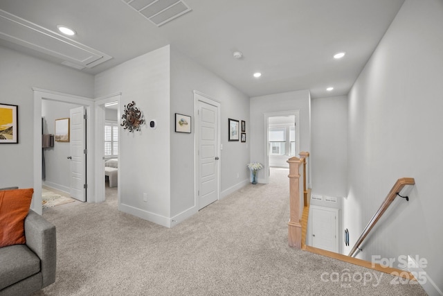 corridor with an upstairs landing, carpet flooring, recessed lighting, and attic access