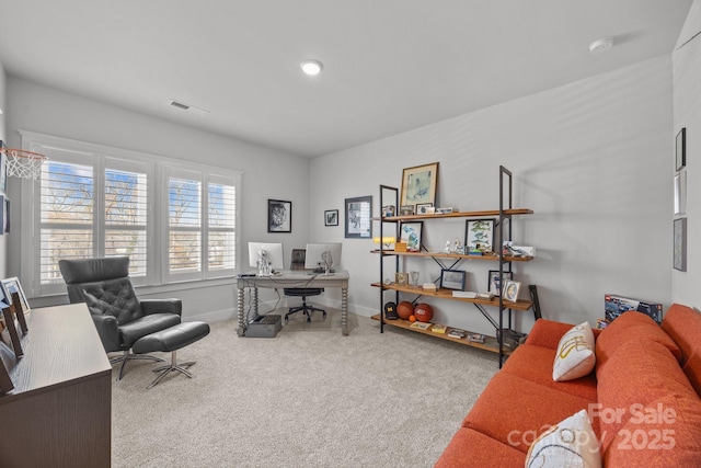 carpeted office space with baseboards and visible vents