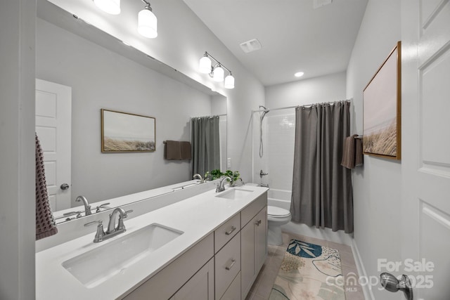 full bath with a sink, visible vents, toilet, and shower / bath combo