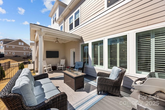 deck featuring outdoor lounge area, a ceiling fan, and fence