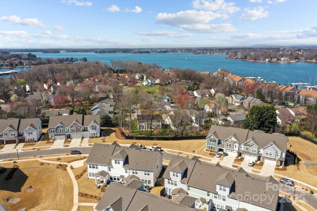 drone / aerial view with a residential view and a water view