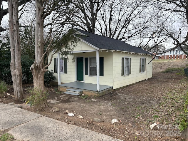 bungalow-style house featuring covered porch and roof with shingles