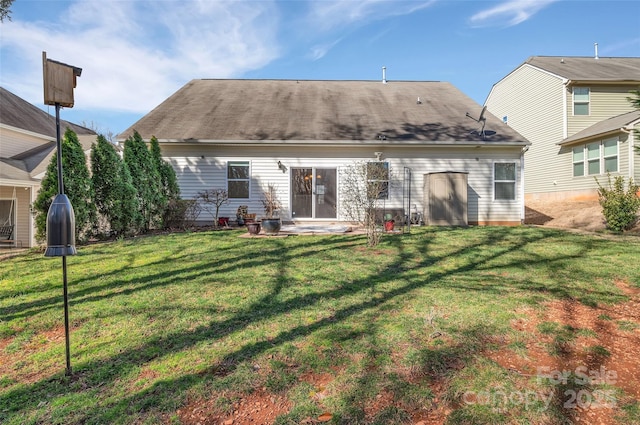 back of property featuring a yard