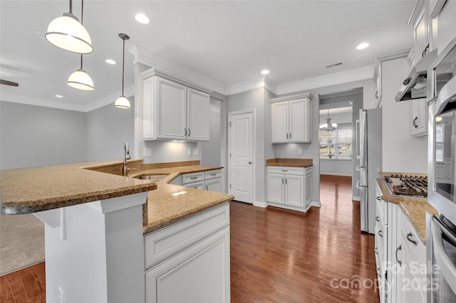 kitchen with ornamental molding, stainless steel appliances, and dark wood-style flooring