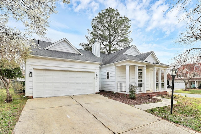 neoclassical home featuring driveway, an attached garage, covered porch, a shingled roof, and a chimney