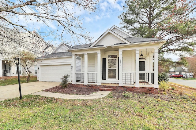 greek revival inspired property with a porch, concrete driveway, and a garage