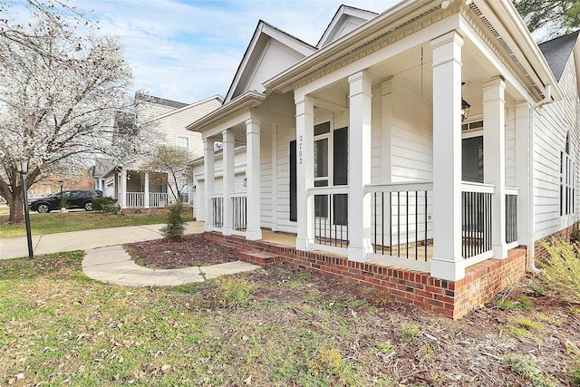 view of home's exterior featuring a porch, concrete driveway, and a garage