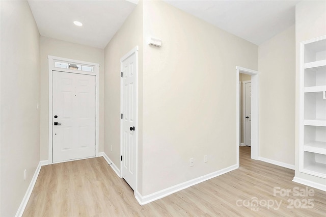 interior space featuring built in features, baseboards, and light wood-style flooring