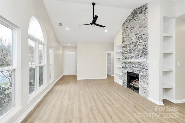 unfurnished living room featuring built in features, visible vents, baseboards, and wood finished floors