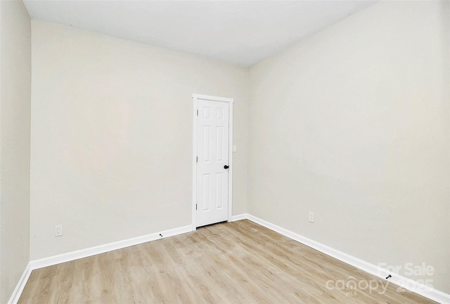 spare room with light wood-type flooring and baseboards