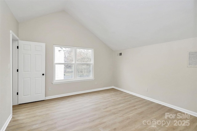 bonus room featuring light wood finished floors, visible vents, baseboards, and lofted ceiling