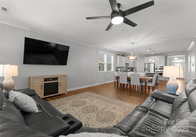 living area featuring crown molding, visible vents, dark wood-type flooring, and baseboards