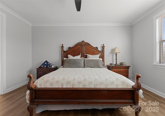 bedroom with a ceiling fan, crown molding, light wood-style floors, and baseboards