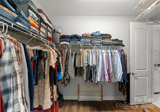 spacious closet featuring washer / clothes dryer and wood finished floors