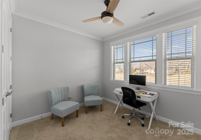 carpeted home office featuring visible vents, baseboards, ceiling fan, and crown molding