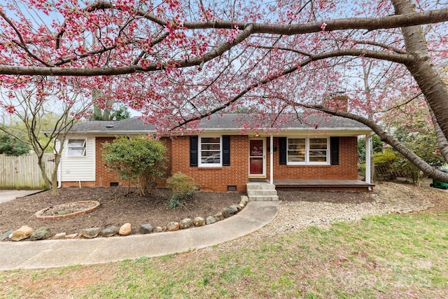 ranch-style house featuring brick siding, a shingled roof, fence, crawl space, and a chimney