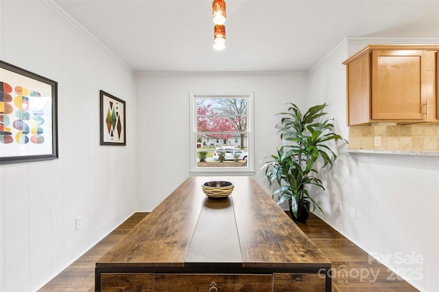 dining room featuring ornamental molding and wood finished floors