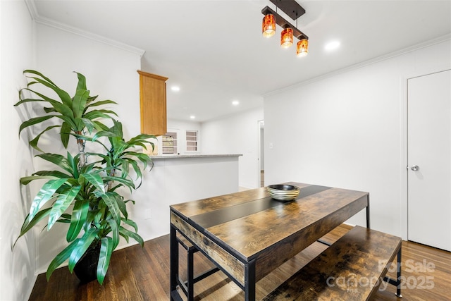 dining area with ornamental molding, wood finished floors, and recessed lighting