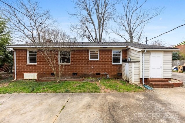 exterior space featuring crawl space and brick siding