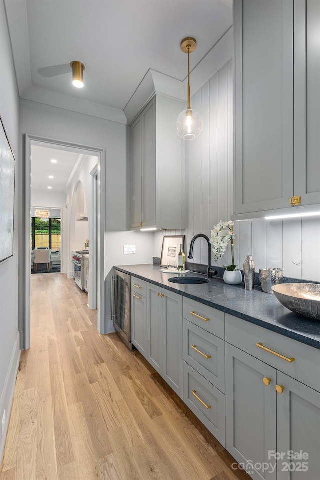 5124 Lansing Dr, Charlotte, NC 28270 - kitchen featuring a sink, gray cabinets, wine cooler, dark countertops, and light wood-style flooring
