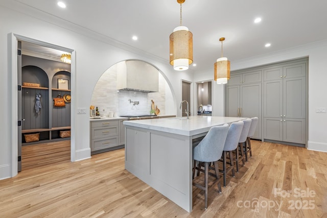 5124 Lansing Dr, Charlotte, NC 28270 - kitchen featuring gray cabinets, light countertops, light wood finished floors, tasteful backsplash, and pendant lighting