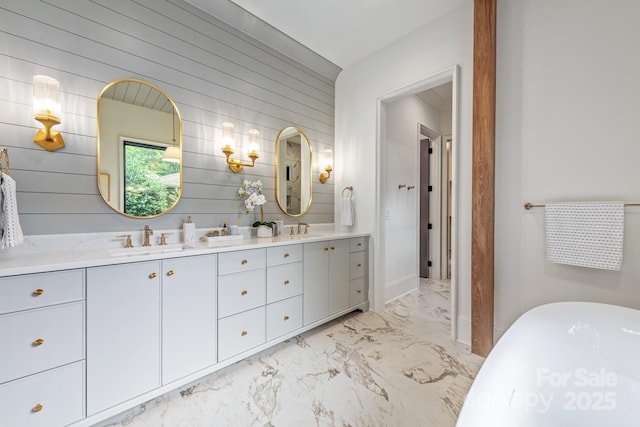 5124 Lansing Dr, Charlotte, NC 28270 - bathroom featuring marble look tiles, wood walls, double vanity, and a freestanding bath