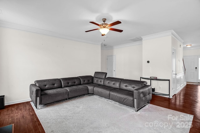 living area with ornamental molding, a ceiling fan, and wood finished floors