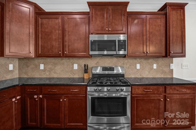 kitchen with dark stone counters, backsplash, and appliances with stainless steel finishes