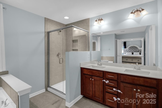 bathroom featuring a sink, connected bathroom, and a stall shower