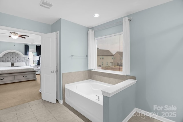 ensuite bathroom featuring a ceiling fan, visible vents, tile patterned floors, a bath, and connected bathroom