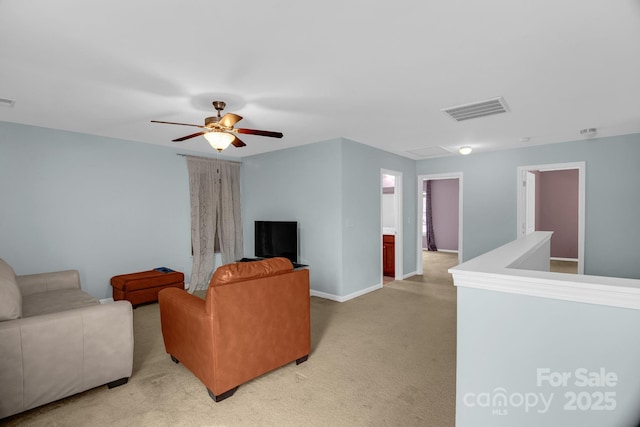 living room featuring light carpet, baseboards, visible vents, and ceiling fan