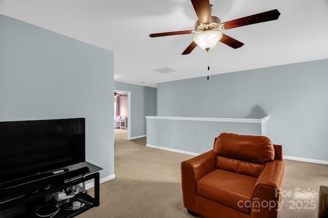 sitting room featuring visible vents, baseboards, a ceiling fan, and carpet flooring