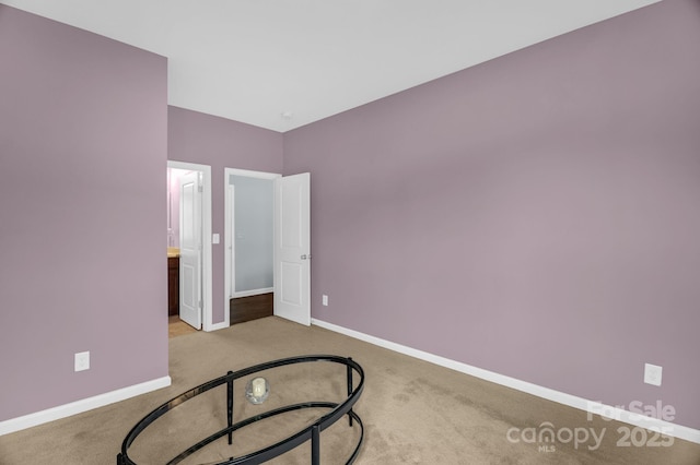 empty room with carpet flooring and baseboards