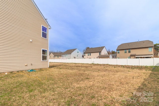 view of yard featuring a residential view and fence