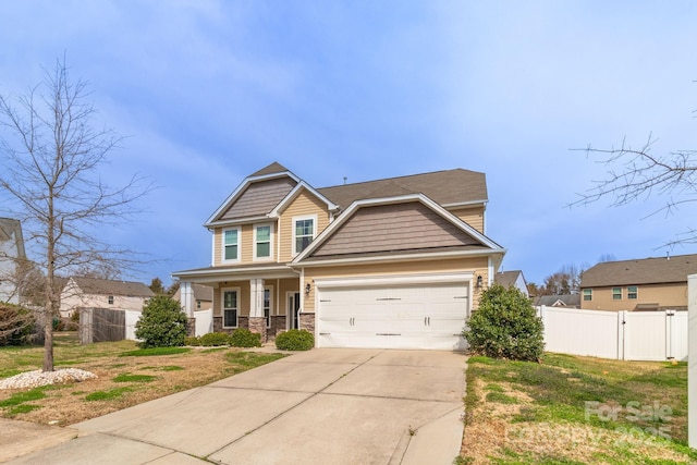 craftsman-style home featuring fence, a garage, stone siding, driveway, and a gate