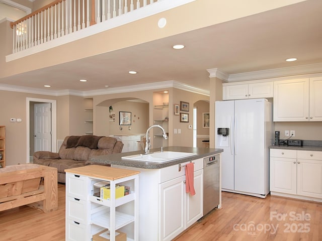 kitchen with white refrigerator with ice dispenser, a sink, light wood-type flooring, dishwasher, and open shelves