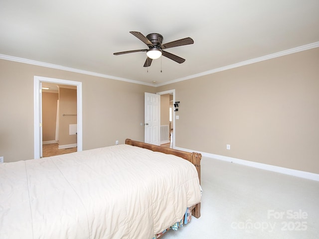 carpeted bedroom featuring connected bathroom, crown molding, baseboards, and a ceiling fan