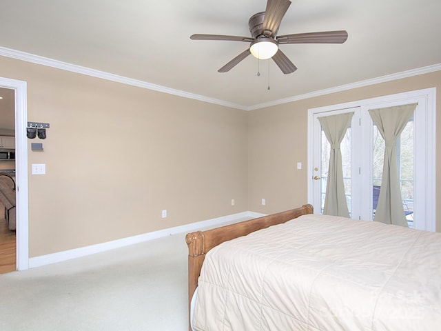 carpeted bedroom with baseboards, ornamental molding, a ceiling fan, and access to exterior