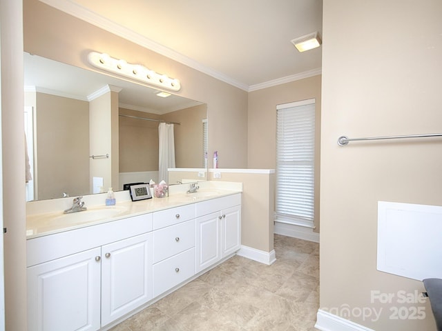 bathroom with baseboards, double vanity, a sink, and crown molding