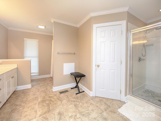 full bath with a stall shower, baseboards, crown molding, and vanity