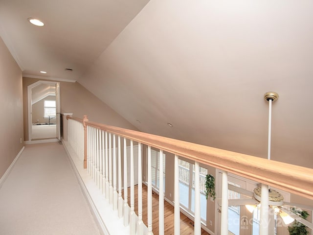 hallway with recessed lighting, visible vents, vaulted ceiling, and baseboards