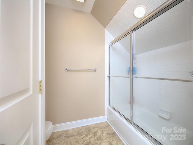 bathroom with baseboards, combined bath / shower with glass door, and toilet