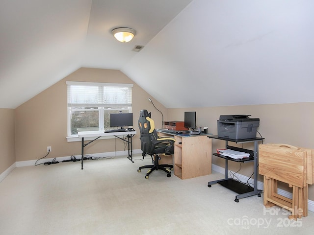 office space featuring light carpet, baseboards, visible vents, and vaulted ceiling