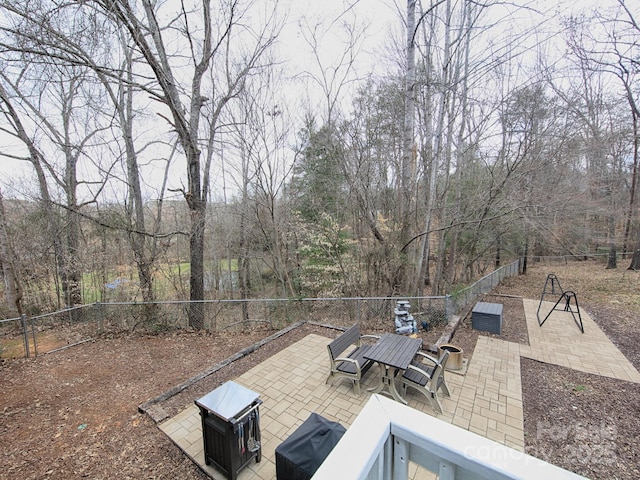 view of patio featuring grilling area, fence, and outdoor dining area