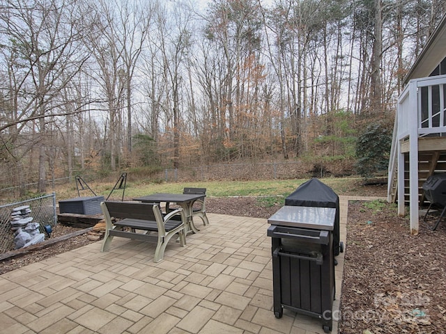 view of patio featuring outdoor dining space and fence