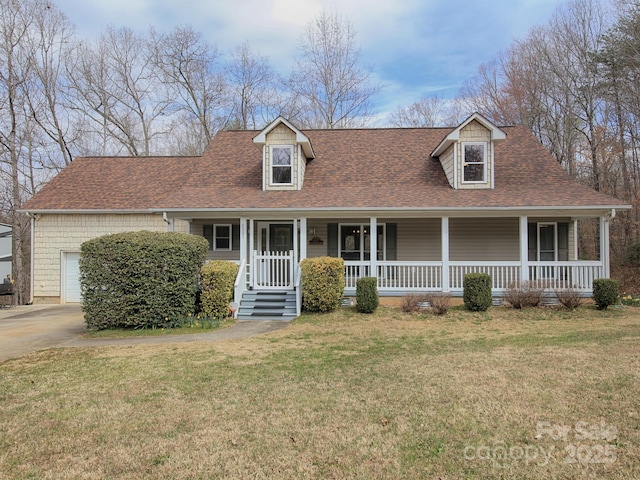 view of front facade featuring covered porch, a shingled roof, a front yard, and a garage