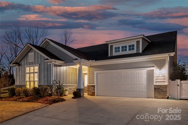 craftsman inspired home featuring stone siding, board and batten siding, and driveway