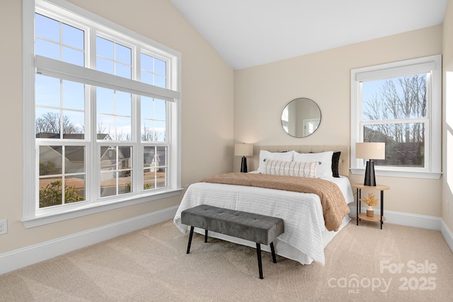 bedroom with vaulted ceiling, carpet, and baseboards